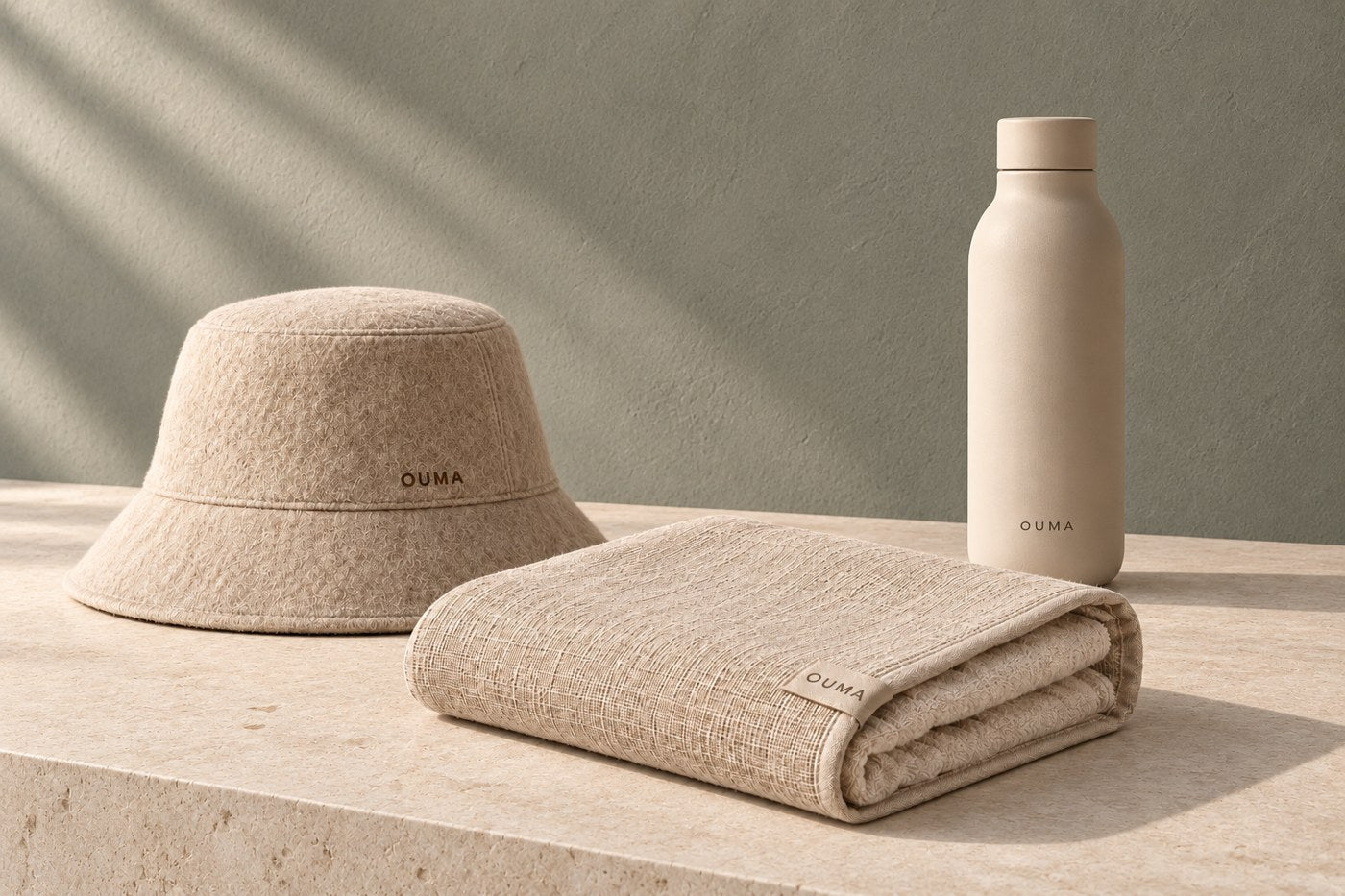 OUMA Sauna Set with a beige sauna hat, sitting towel and water bottle — AI-generated bundle concept.
